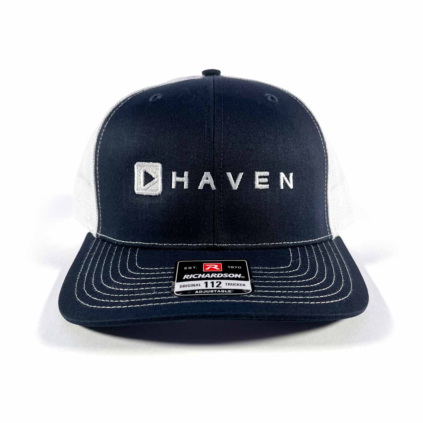 Navy blue cap with 'HAVEN' logo on a white background