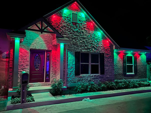 House exterior with red and green lights during nighttime