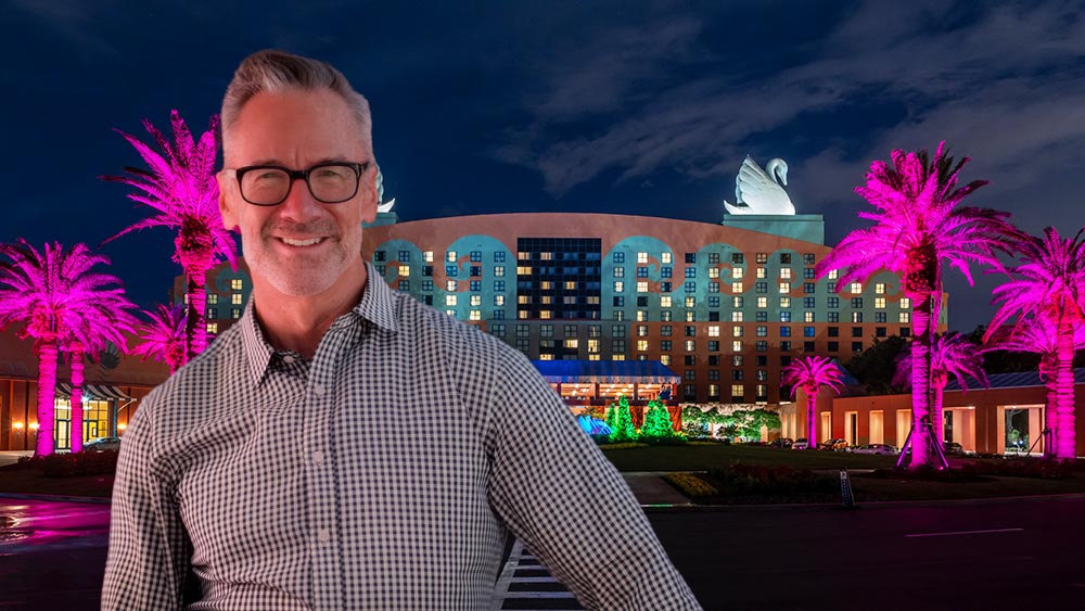 Man standing in front of Walt Disney World Resort with swan