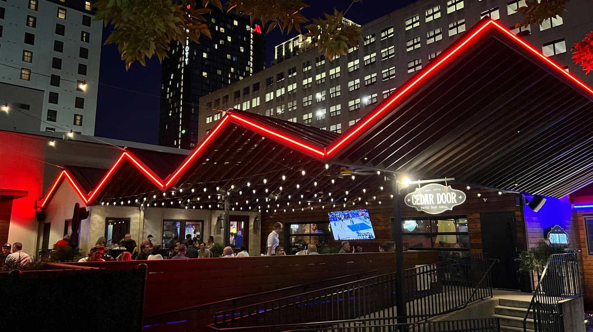 Restaurant patio glowing with permanent bistro and accent lighting