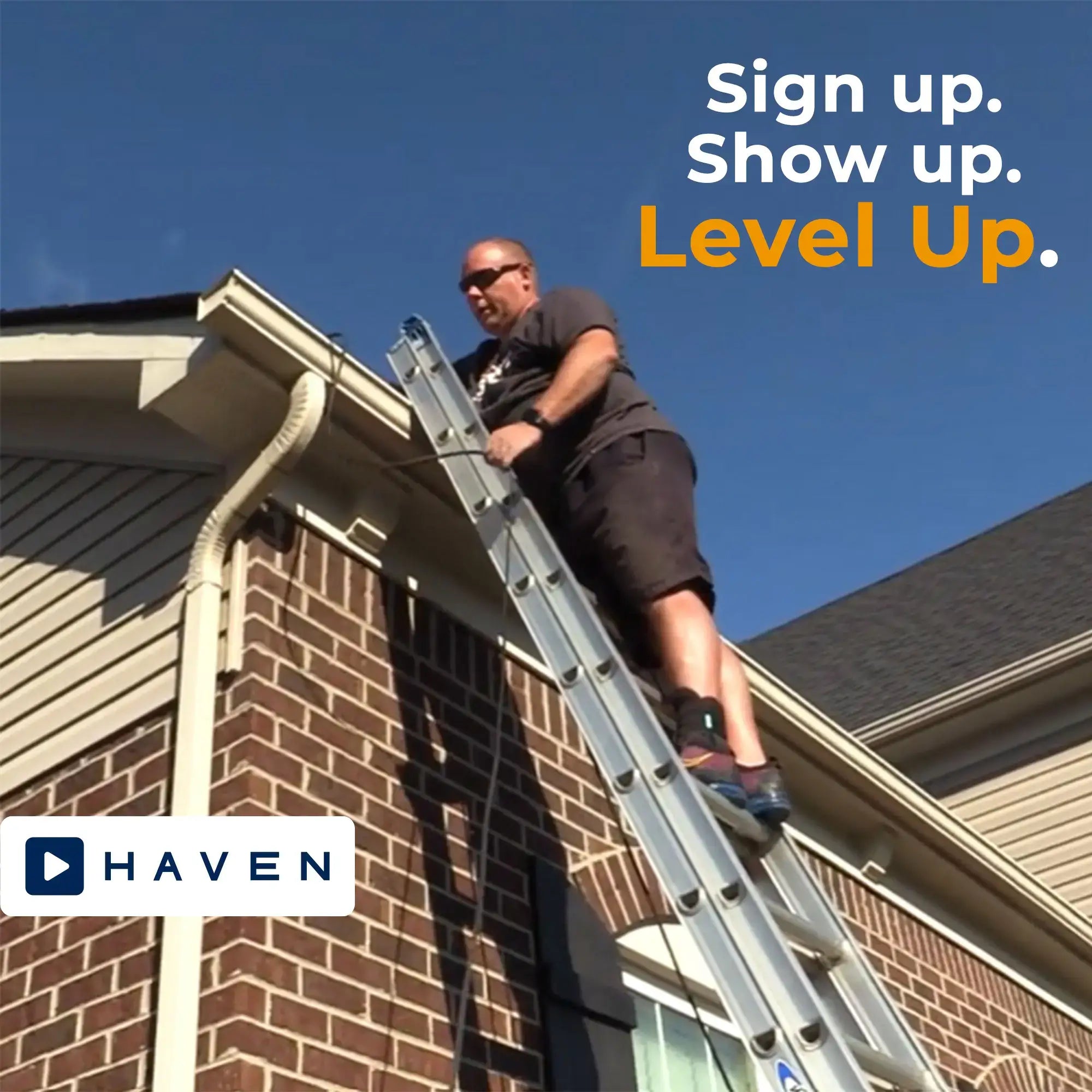 Haven Lighting Installer standing on a ladder running a wire through a downspout.