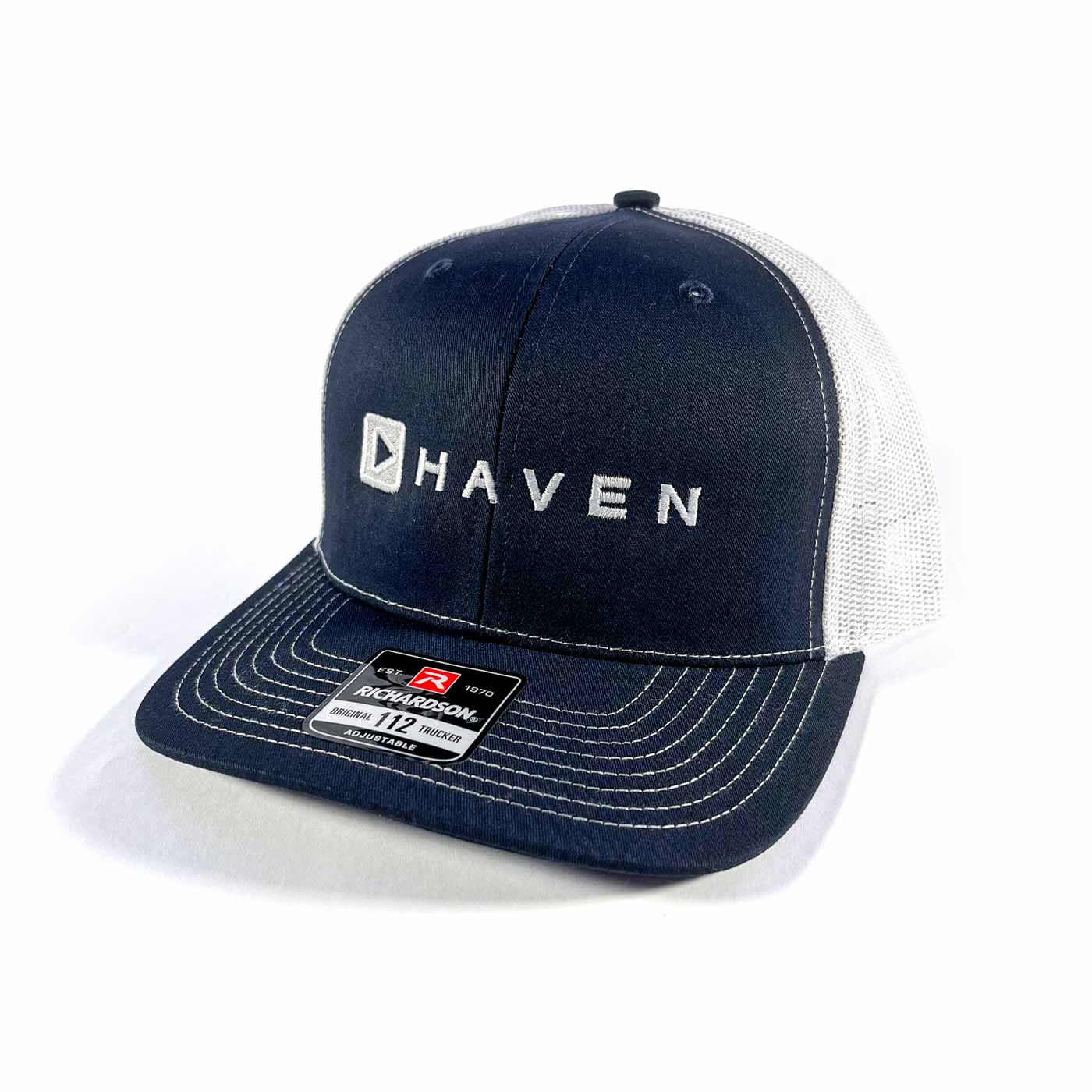 Navy blue cap with 'Haven' logo on a white background