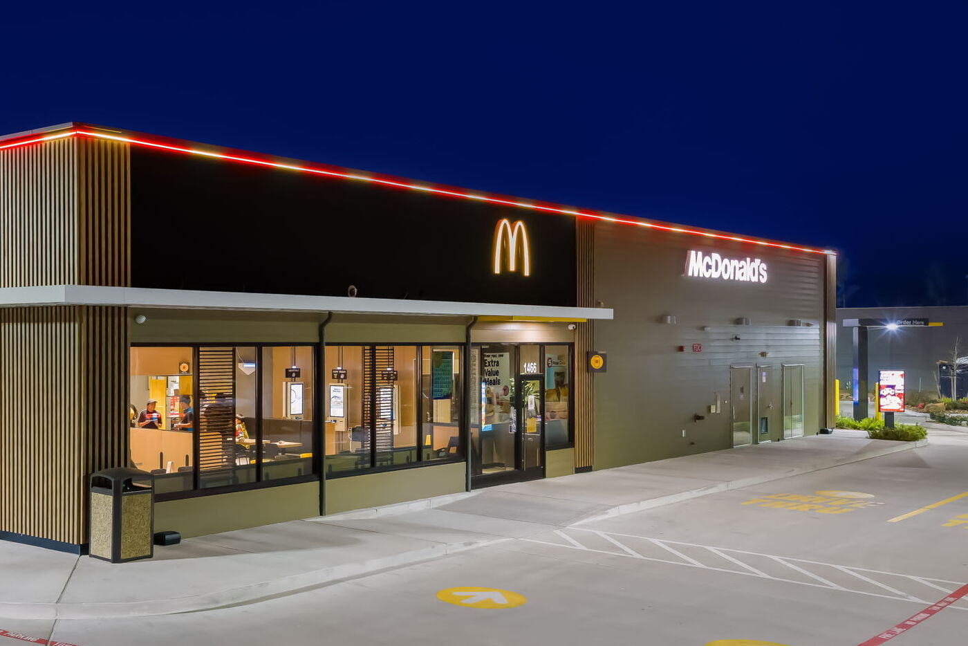 McDonald's restaurant exterior at night with illuminated sign