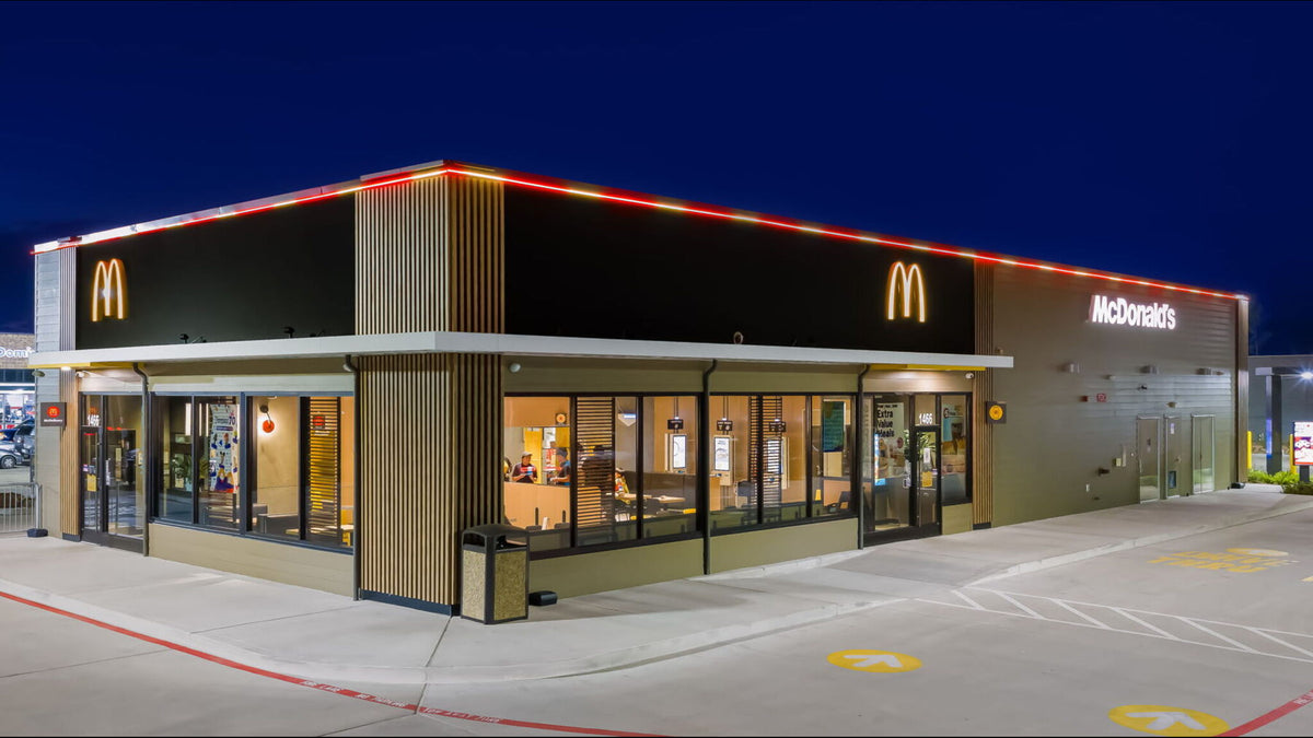 Fast-food restaurant roofline outlined in permanent smart lighting at night