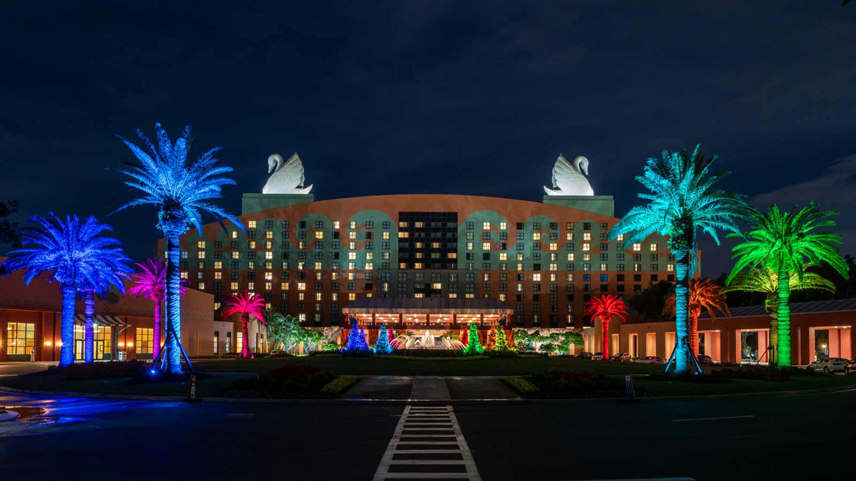 Resort building outlined in permanent color lighting at night