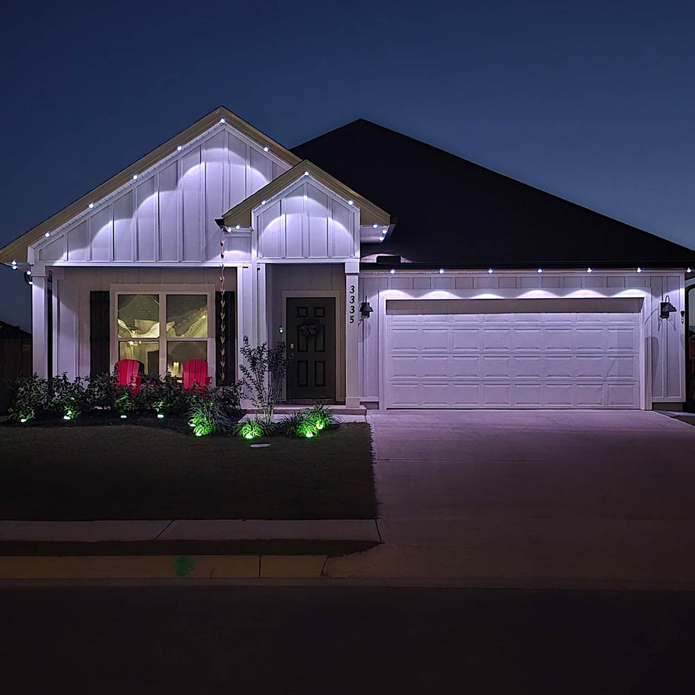 Home outlined in Genesis permanent roofline lighting at night